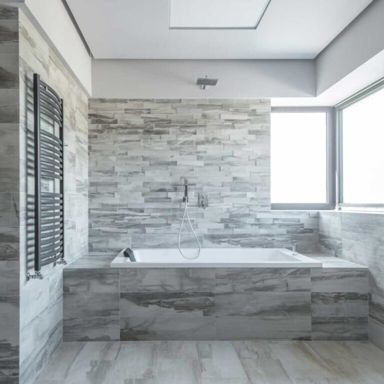 Vein-matched marble-look porcelain shower walls in a Sleepy Hollow bathroom renovation